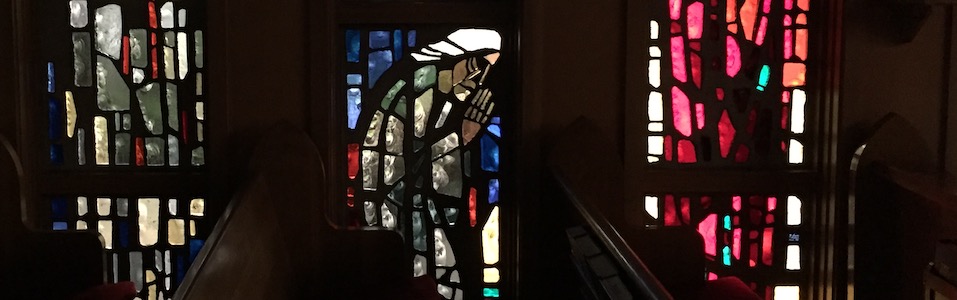 Stained glass image of man seated in prayer from Good Samaritan Church in Corvallis, Oregon