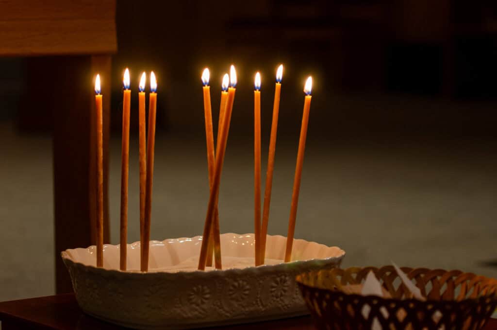 Candles lit in a ceramic dish at The Episcopal Church of the Good Samaritan.