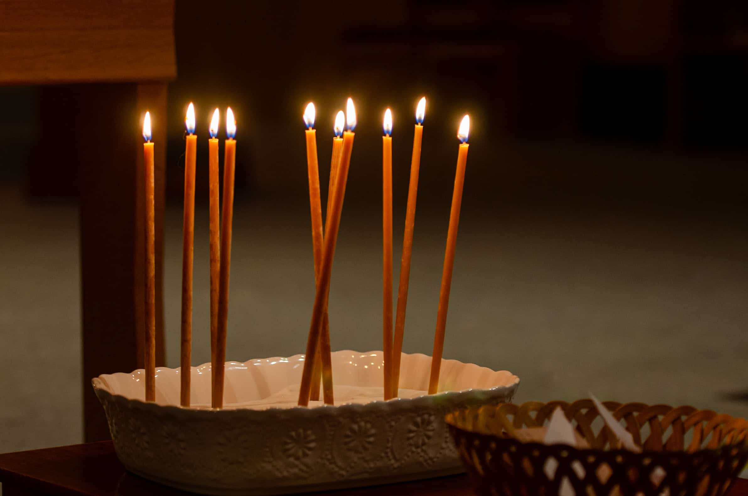 Candles lit in a ceramic dish at The Episcopal Church of the Good Samaritan.