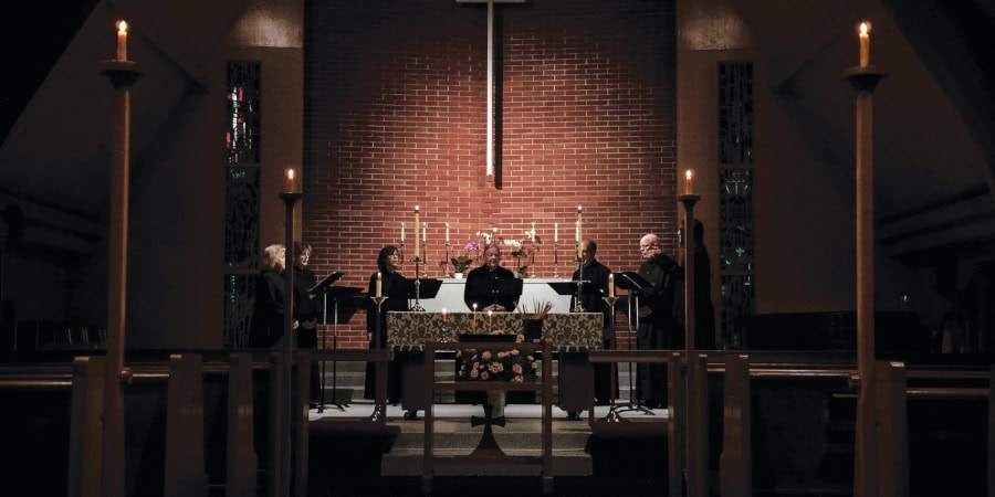 Interior view of the church altar with candles and cross.