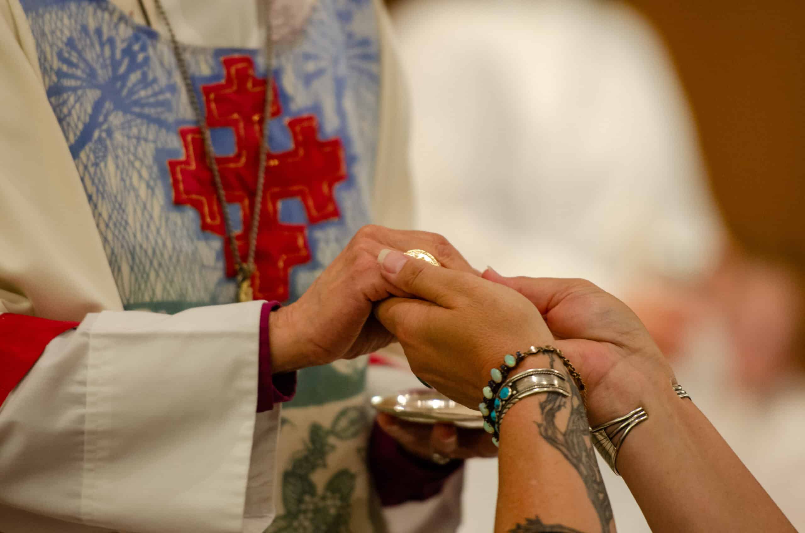 Clergy member administering Holy Communion at The Episcopal Church of the Good Samaritan.