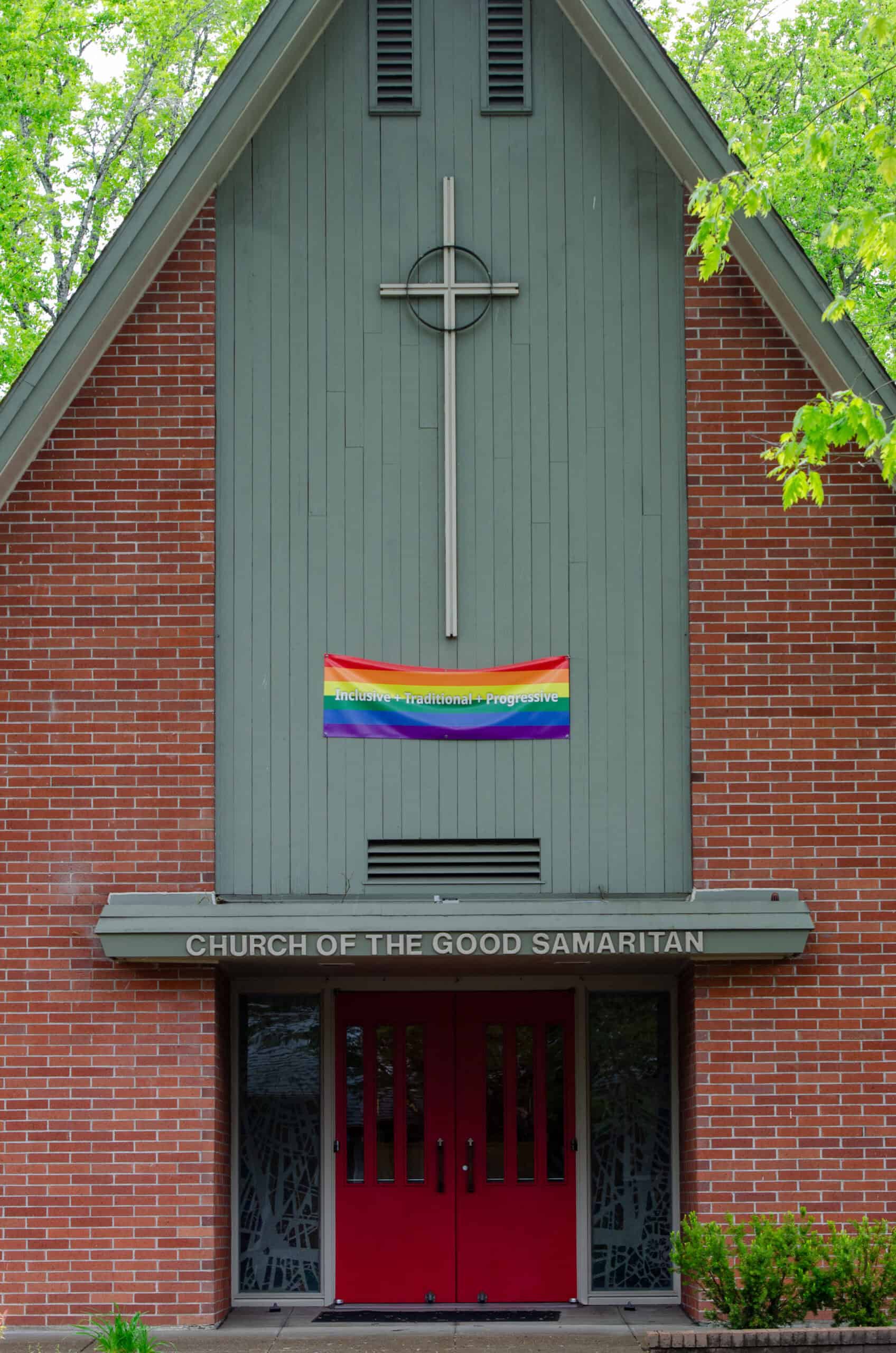 The Episcopal Church of the Good Samaritan with rainbow pride banner on facade.
