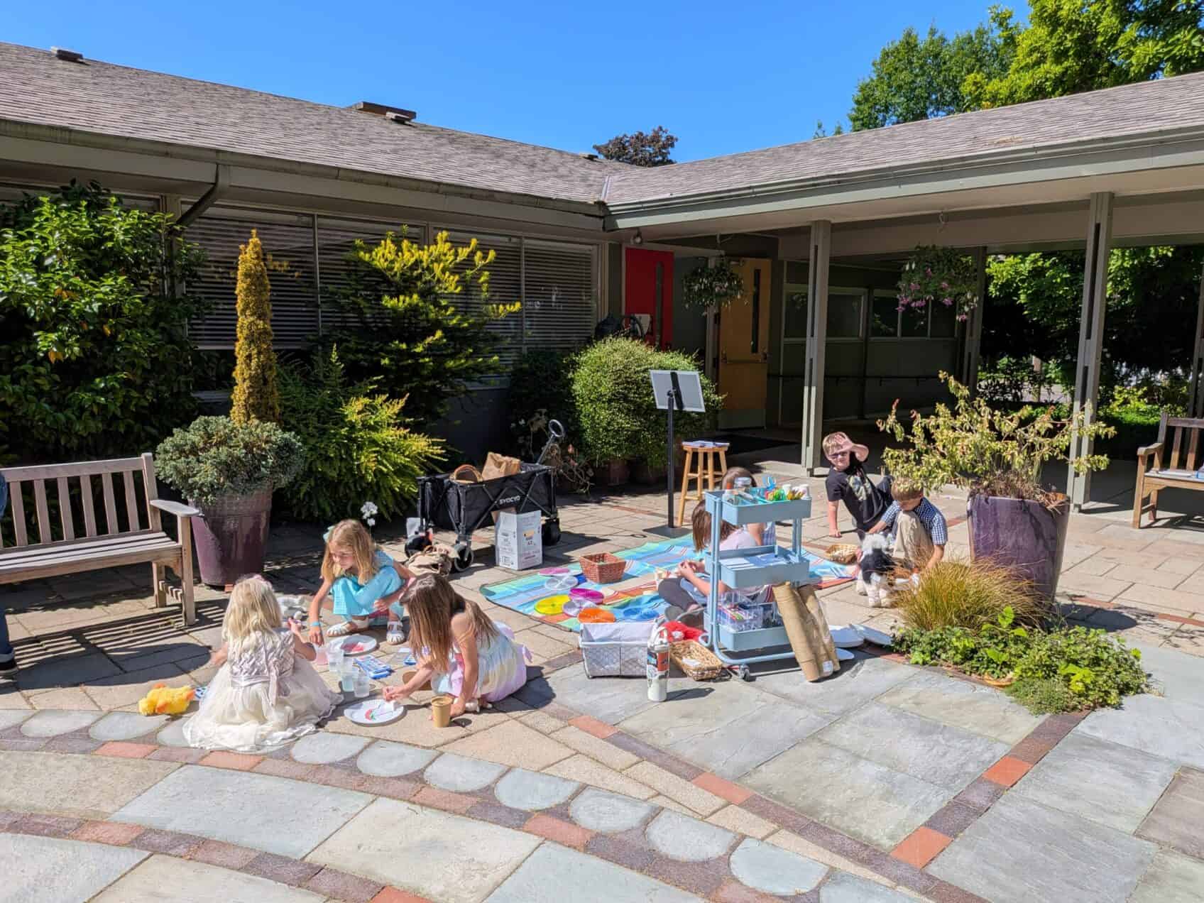 Children playing and creating art outdoors at The Episcopal Church of the Good Samaritan.