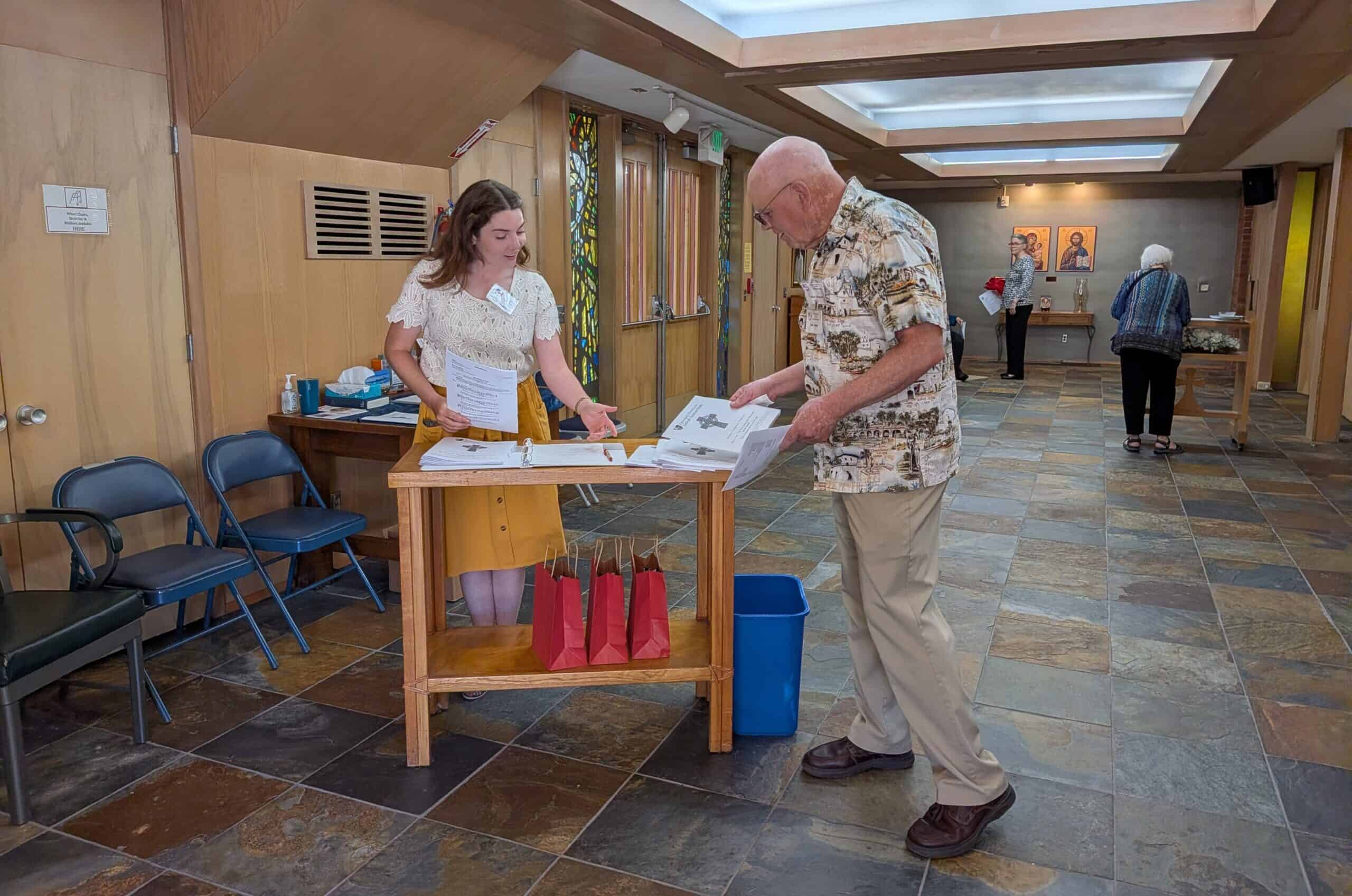 Visitor registering at the church reception desk inside the Episcopal Church of the Good Samaritan.